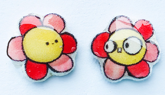 Small handmade flower stud earrings with pink and yellow floral monster design shown on a clean background.