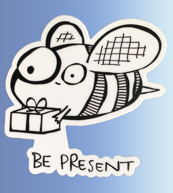 A black and white cartoon bee holding a small gift with the words “Be Present” written below.