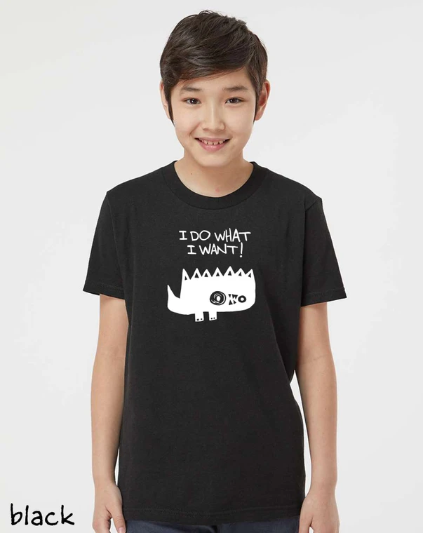Model wearing white funny monster graphic t-shirt that says “I Do What I Want!" on black youth tee.