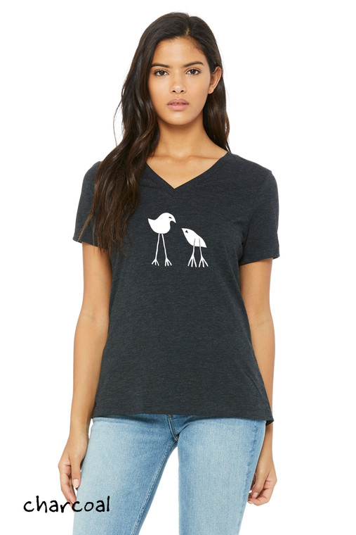 Woman wearing minimalist two birds charcoal t shirt parent and baby bird simple graphic design.