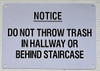 BUILDING NOTICE: DO NOT THROW TRASH IN HALLWAY OR BEHIND STAIRCASE SIGN