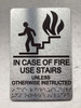 NYC IN CASE OF FIRE USE STAIRS UNLESS OTHERWISE INSTRUCTED COMPLIANCE SIGN WITH RAISED LETTERS COMPLIANCE SIGN