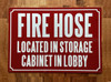 FIRE HOSE LOCATED IN STORAGE CABINET IN LOBBY SAFETY SIGN
