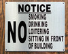 NO SMOKING DRINKING LOITERING SITTING IN FRONT OF BUILDING SIGN