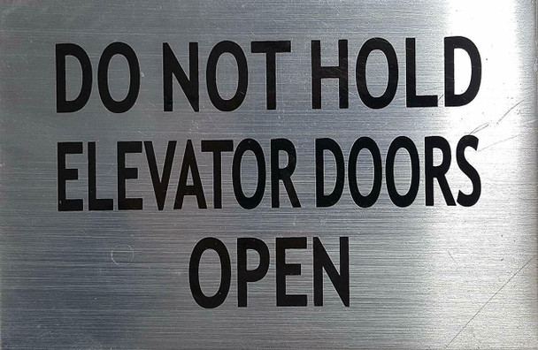 SIGNS DO NOT HOLD ELEVATOR DOORS OPEN