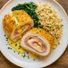 Chicken Cordon Bleu dinner with breaded chicken breast, ham, Swiss cheese, herbed brown rice, and sautéed spinach.