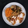 Slow-roasted turkey dinner with traditional sides and savory gravy.