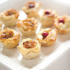 12 - Caramelized Onion & Feta Pastry Blossoms: bites of flaky puff pastry, savory Feta cheese, and lush caramelized onion topping