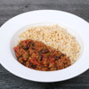 Turkey chili with black beans beside herb brown rice in a white bowl