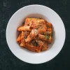 Top-down view of rigatoni with sausage and cherry pepper marinara