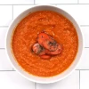 Top-down view of carrot ginger soup in a white bowl