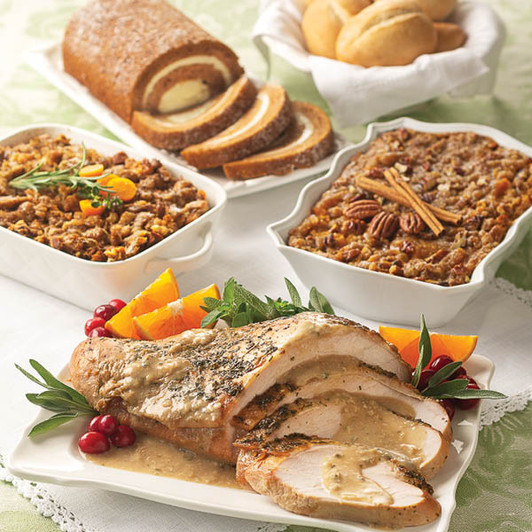 Turkey Breast with Gravy Complete Dinner featuring sliced roasted turkey breast, traditional herb stuffing, sweet potato casserole with pecans, homestyle gravy, artisanal rolls, and pumpkin swirl cake.