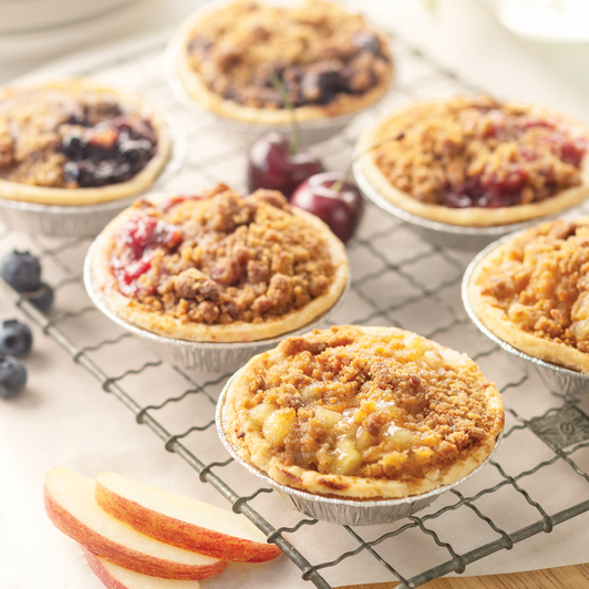 Individual Fruit Pie Sampler with apple, cherry, and blueberry mini fruit pies topped with golden streusel; choose six or twelve individual desserts.