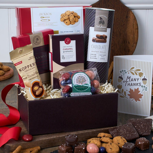 Thanksgiving Gift Basket Classic overflowing with gourmet chocolates, artisan cookies, cocoa-dusted almonds, and holiday treats in an autumn arrangement