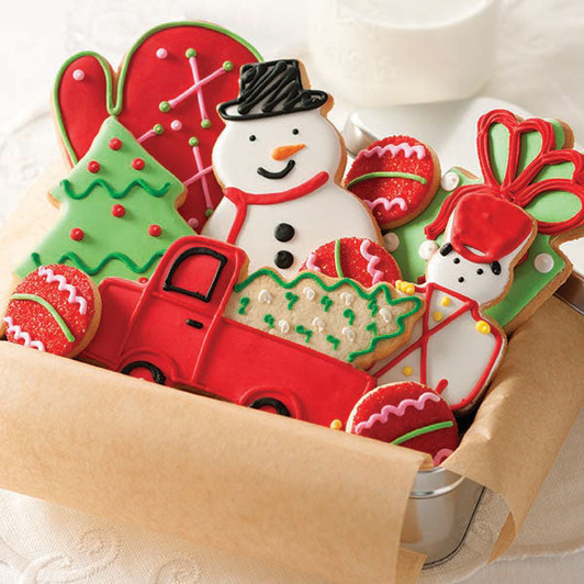 Winter Wonderland butter cookies decorated as holiday trees, a snowman, mittens and gifts.
