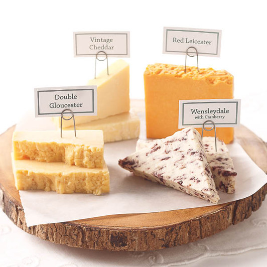 Four labeled British cheeses: aged Cheddar, Red Leicester, Double Gloucester and cranberry Wensleydale.