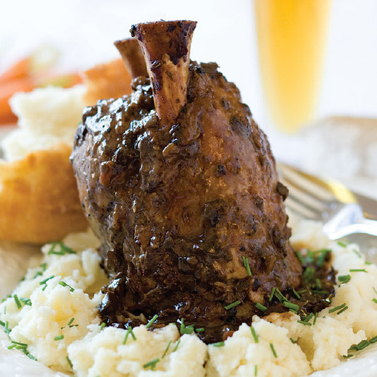 Braised pork shank served with sauce; sides not included
