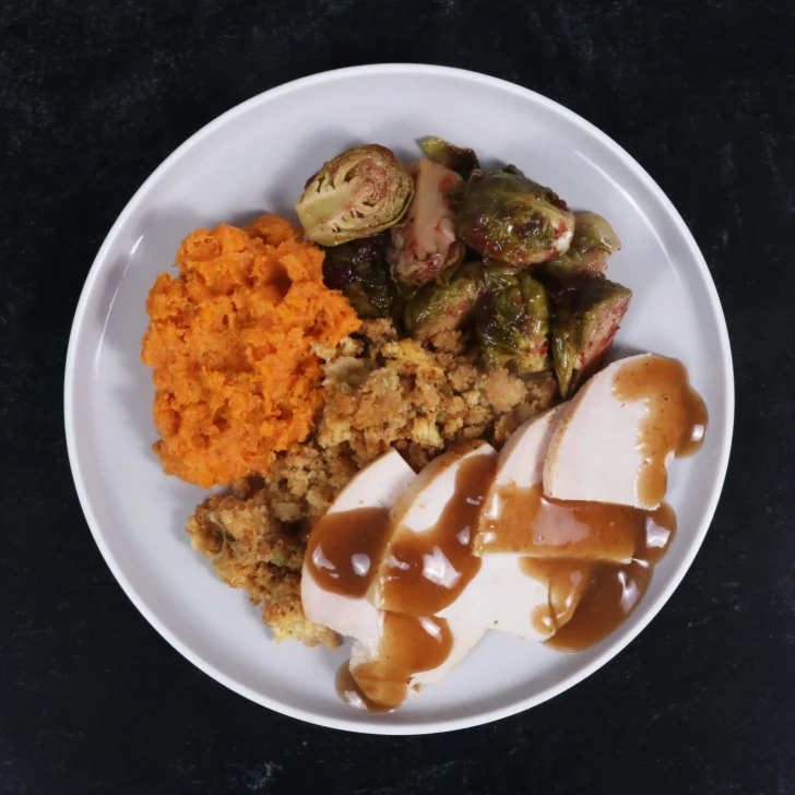 Slow-roasted turkey dinner with traditional sides and savory gravy.