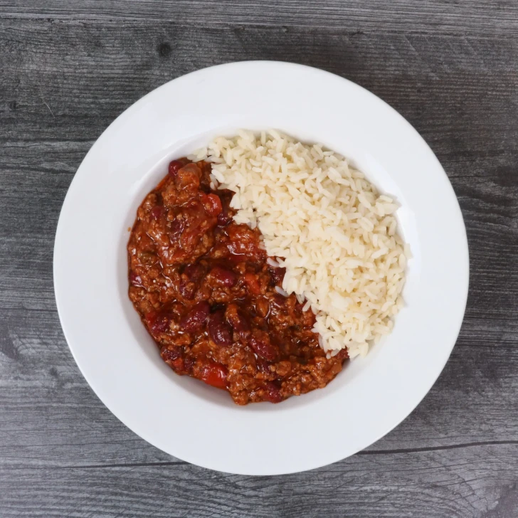Prepared beef chili dinner with traditional chili spices and white rice.