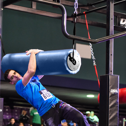 Athlete hanging on blue aerial barrel