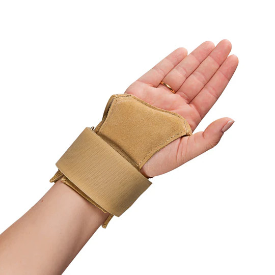 Gymnast wearing a EZY Pro Wrist Support Brace with removeable palm pad back of right hand
