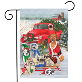 Briarwood Lane Holiday Dogs Christmas Garden Flag with cheerful dogs in winter attire on a sled.