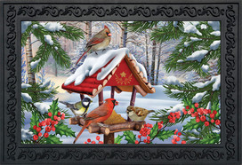 Briarwood Lane Gathered Together Winter Doormat with cardinals, chickadees, and snowy birdfeeder scene printed.