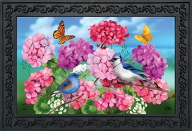 Briarwood Lane Geraniums In Bloom Spring Doormat with colorful flowers, butterflies, and birds on decorative mat.
