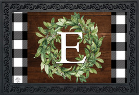 Briarwood Lane Wreath Monogram Letter E doormat with black and white checkered border and green wreath.