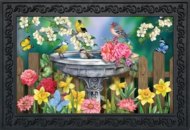 Briarwood Lane Birdbath in Bloom doormat with colorful flowers, birds, and butterflies on decorative background.