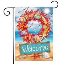 Briarwood Lane Coral Wreath Garden Flag with seashells and starfish on a beach background welcomes guests.