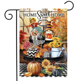 Briarwood Lane Autumn Memories Garden Flag with scarecrow, pumpkins, and sunflowers on black stand.