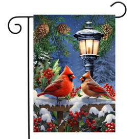 Winter Glow Cardinals Garden Flag with two cardinals, snow, lamp post, and red berries on fence.