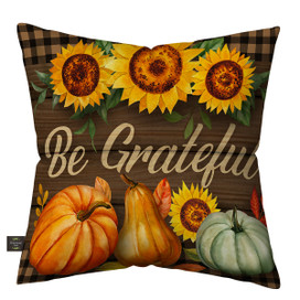 Be Grateful Fall Burlap Pillow with sunflowers, pumpkins, and pears on a brown plaid background.
