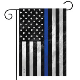 Honor Protect Serve Garden Flag with blue line, black, white, and stars on a pole.