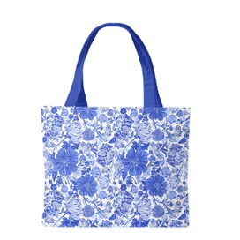 Blue and white floral canvas tote bag with blue handles on a plain white background shown.