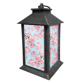 Black Cherry Blossoms Lantern with pink floral design on light blue background and metal frame.