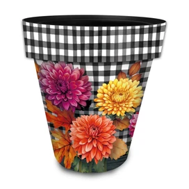 Large black and white checkered planter with pink, orange, and yellow flowers and fall leaves design.