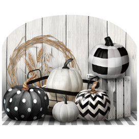 Black and white pumpkins in various patterns on a tray with a wheat wreath nearby.