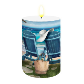 Seaside Escape Flameless Candle with serene beach scene featuring blue chairs, hat, and wicker bag.