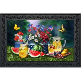 American Lemonade Doormat with patriotic floral design and refreshments on grass with black frame.