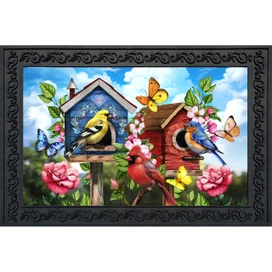 Floral Birdhouses Doormat with colorful birds, butterflies, and flowers surrounding two birdhouses on a blue background.