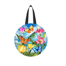 Sunshine Butterflies colorful tote bag with floral design, butterflies and blue sky on circular wood hanger.