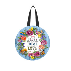 Round blue woodgrain door hanger with colorful floral wreath and Bless This Home With Love text.