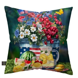 American Lemonade Indoor/Outdoor Pillow with patriotic floral design and lemonade pitcher on grass.