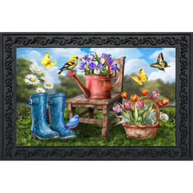 In the Garden Doormat with colorful flowers, birds, and boots on a green grassy background.