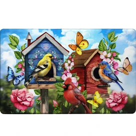 Floral Birdhouses Comfort Mat with colorful birdhouses, birds, butterflies, and flowers on a blue background.