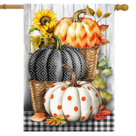 Pumpkin Basket Stack House Flag with orange, black and white pumpkins in wicker baskets on plaid background.