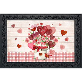 Framed Love Bouquet Doormat with pink flowers, hearts, and red accents on white wood background.