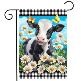 Black and white cow surrounded by white daisies and butterflies on checkered garden flag.